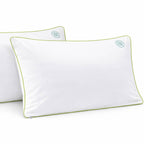 two anti dust mite pillow cases with green piping and dust mite symbol 