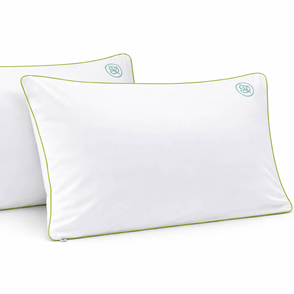 two anti dust mite pillow cases with green piping and dust mite symbol 