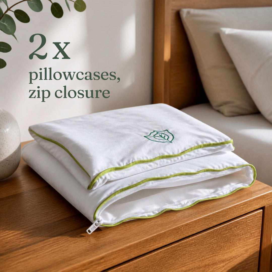 Two folded anti dust mite eucalyptus silk pillowcases with zip closure and green piping, set of 2