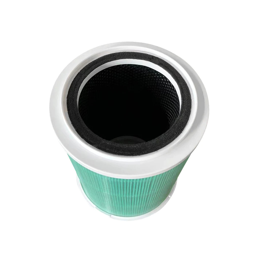 Close-up top view of the cylindrical True HEPA replacement filter, showing the green pleated glass fibre material and black foam seal designed to prevent air leakage and capture dust mites.